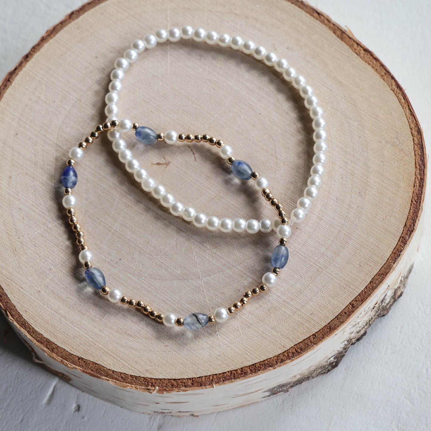 Paired Pearl, Gold, and Blue Bracelets