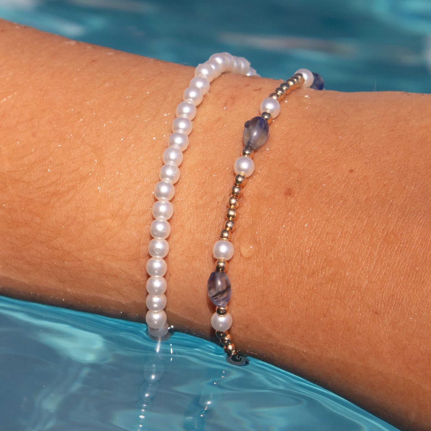 Paired Pearl, Gold, and Blue Bracelets
